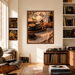 May include: A framed wall art print titled Vinyl & Vino featuring a record player, a glass of red wine, and a bowl of grapes. The artwork is displayed in a room with a bookshelf, a record player console, and two additional framed prints on the wall.