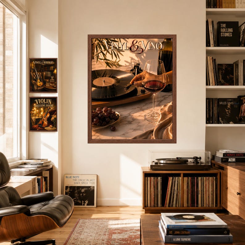 May include: A framed wall art print titled Vinyl & Vino featuring a record player, a glass of red wine, and a bowl of grapes. The artwork is displayed in a room with a bookshelf, a record player console, and two additional framed prints on the wall.