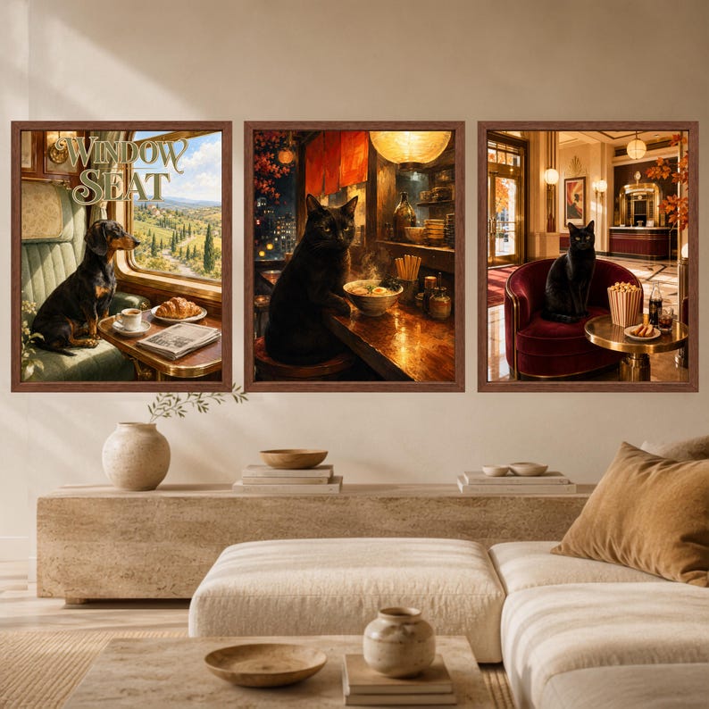 May include: Three framed wall art prints featuring a dachshund on a train with the text Window Seat, a black cat at a ramen bar, and a black cat in a hotel lobby. Each print is enclosed in a brown frame, displaying detailed scenes with warm lighting and rich colors.