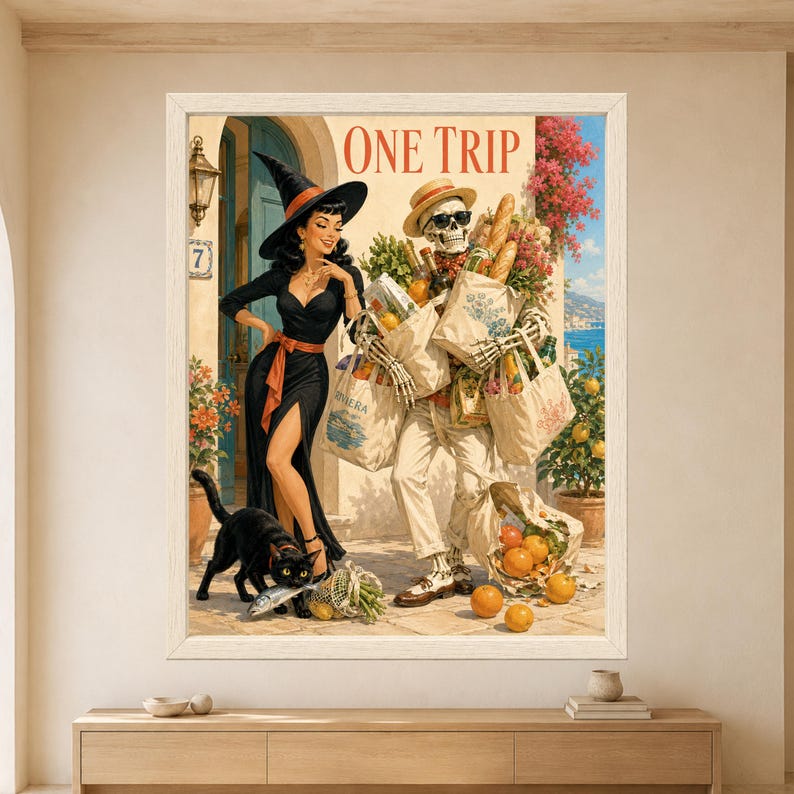 Framed One Trip wall art showing a skeleton overloaded with grocery bags, baguettes, bottles and produce beside a smiling retro witch while a black cat steals a fish on a sunny Mediterranean terrace.