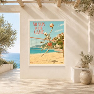 May include: A rectangular wall art print featuring a skeleton playing volleyball on a sandy beach. The skeleton wears red shorts and jumps to hit a volleyball over a net. The text NO SKIN IN THE GAME is printed in red at the top. The background shows a blue ocean, a coastal town, and a clear sky.