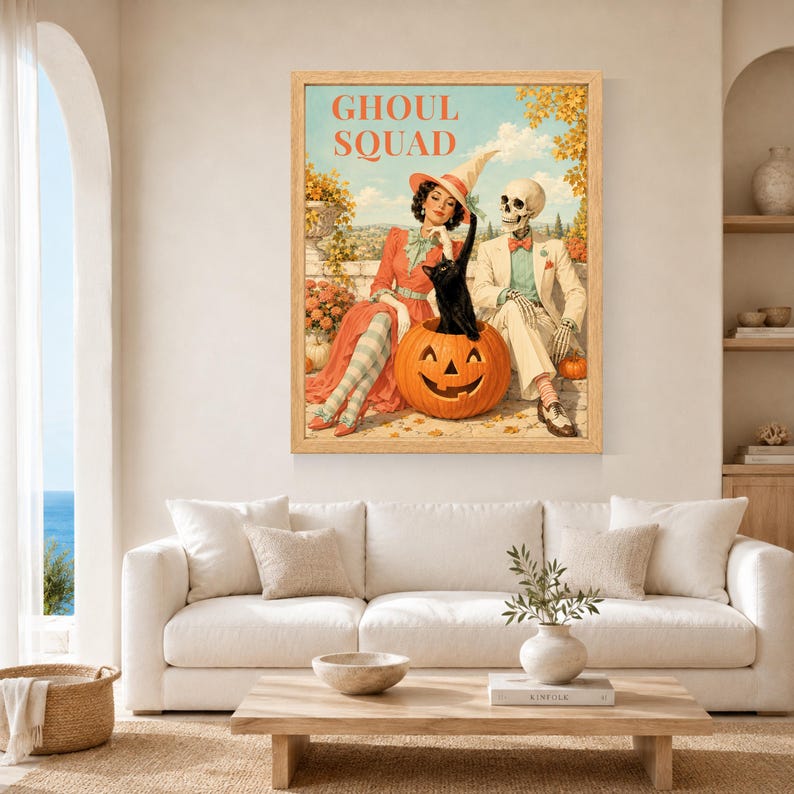 May include: A framed wall art print titled GHOUL SQUAD featuring a vintage-style illustration of a person in a witch hat, a skeleton in a suit, and a black cat sitting inside a large orange jack-o'-lantern against a backdrop of autumn trees.