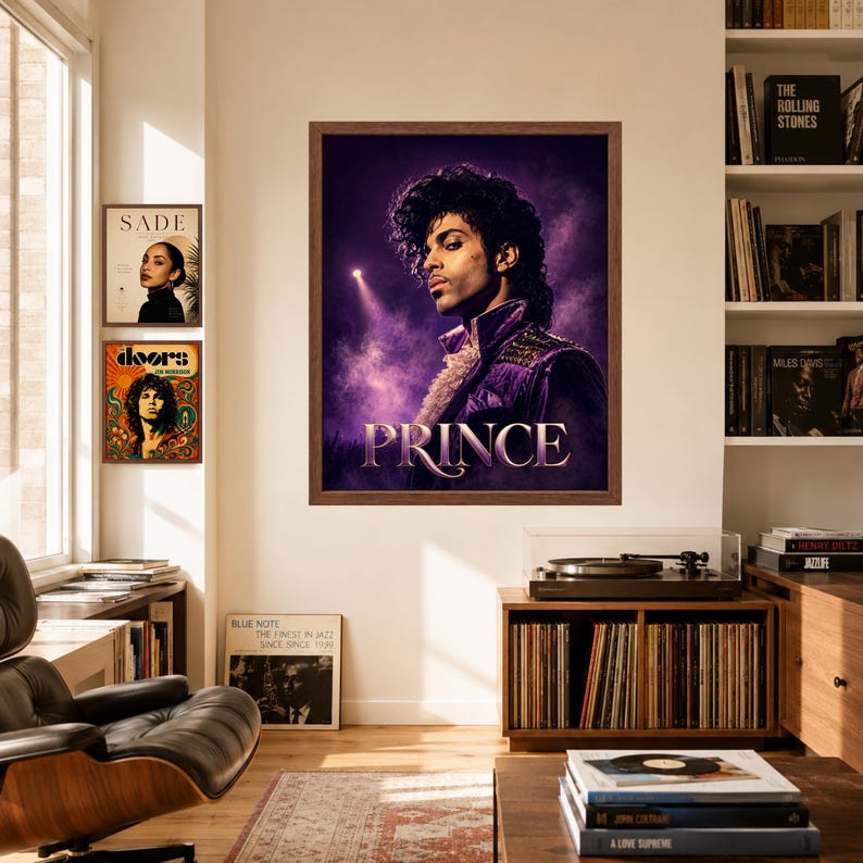 May include: A framed wall poster featuring a portrait of the musician Prince in a purple jacket against a dark, smoky background with a spotlight. The name PRINCE is printed in large, stylized white letters at the bottom of the rectangular artwork.