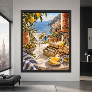 Framed Mediterranean kitchen wall art showing an open tin of sardines, martini with olives, lemons, bread and green olives on a marble table overlooking the blue sea and Amalfi Coast.