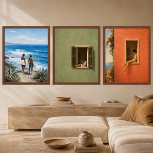 May include: A set of three square framed wall art prints. The left print shows two people with surfboards on a beach overlooking the blue ocean. The middle print features a person reading in a window on a green wall. The right print shows a person sitting in a window on an orange wall.