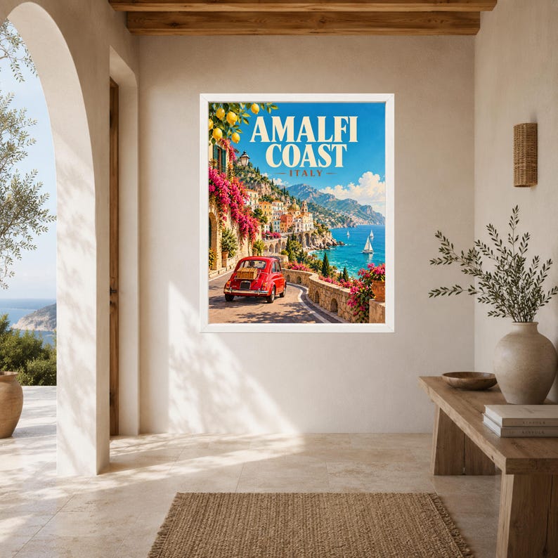 May include: A framed travel poster featuring a red vintage car on a coastal road along the Amalfi Coast, Italy. The scene includes vibrant pink bougainvillea, yellow lemons, blue sea, and distant mountains under a clear sky with the text Amalfi Coast Italy.