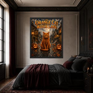 May include: A framed wall art print titled The Orange Cat of Witch Lane featuring a central orange cat sitting on a cobblestone street at night, surrounded by glowing jack-o'-lanterns, old buildings, and a full moon in the dark sky.