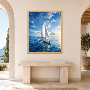May include: A framed wall art print featuring a white sailboat with a single mast sailing across deep blue ocean waters under a bright sky with scattered white clouds and a soft golden sun glow on the horizon during the daytime.