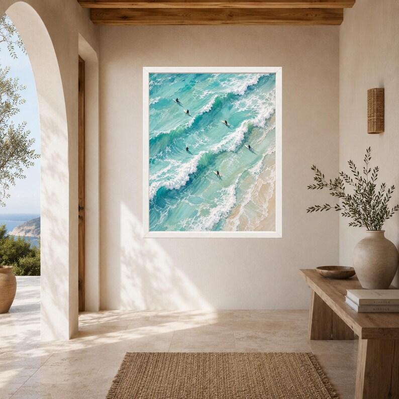 May include: A framed wall art print featuring an aerial view of turquoise ocean waves crashing onto a sandy beach. Several small figures on surfboards are positioned within the rolling white-capped waves, rendered in a textured painterly style.