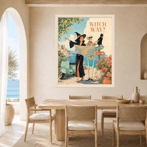 Puede incluir: Una impresi&oacute;n art&iacute;stica enmarcada titulada WITCH WAY? que muestra a una bruja con vestido negro y un esqueleto con gafas de sol mirando un mapa. Se ven un scooter verde claro, un gato negro, limoneros y se&ntilde;ales de Coast Road y Cliff Road.
