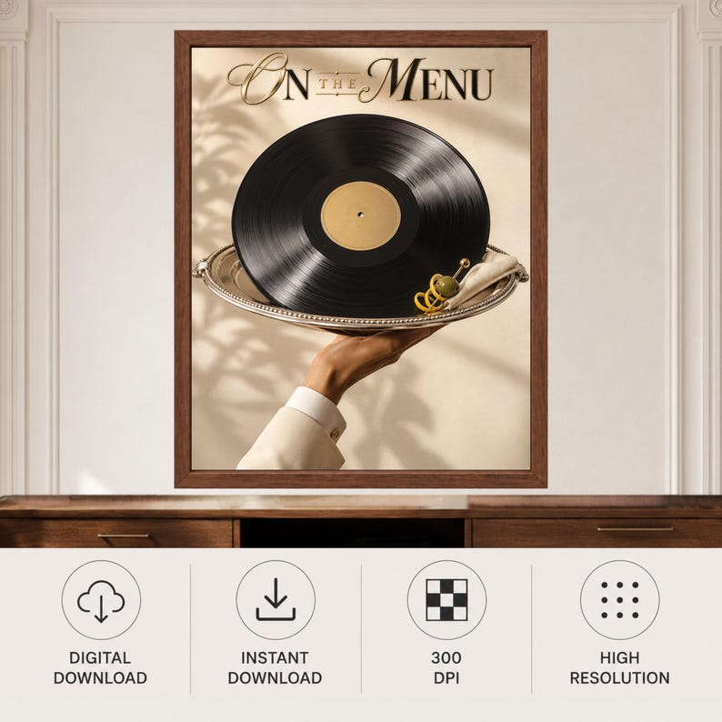May include: A framed wall art print titled On The Menu featuring a black vinyl record served on a silver platter. A green olive with a yellow lemon twist garnish sits on the edge of the tray. The background shows soft shadows of foliage.