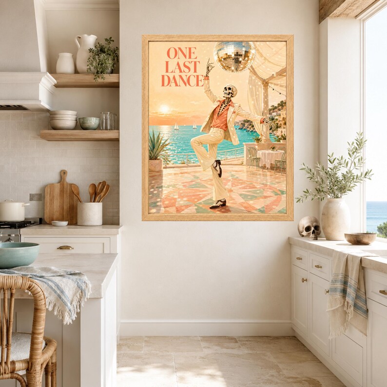 May include: A framed wall art print titled ONE LAST DANCE featuring a skeleton wearing a light-colored suit and orange shirt dancing on a terrace overlooking the ocean. A disco ball hangs above the skeleton against a sunset sky background.