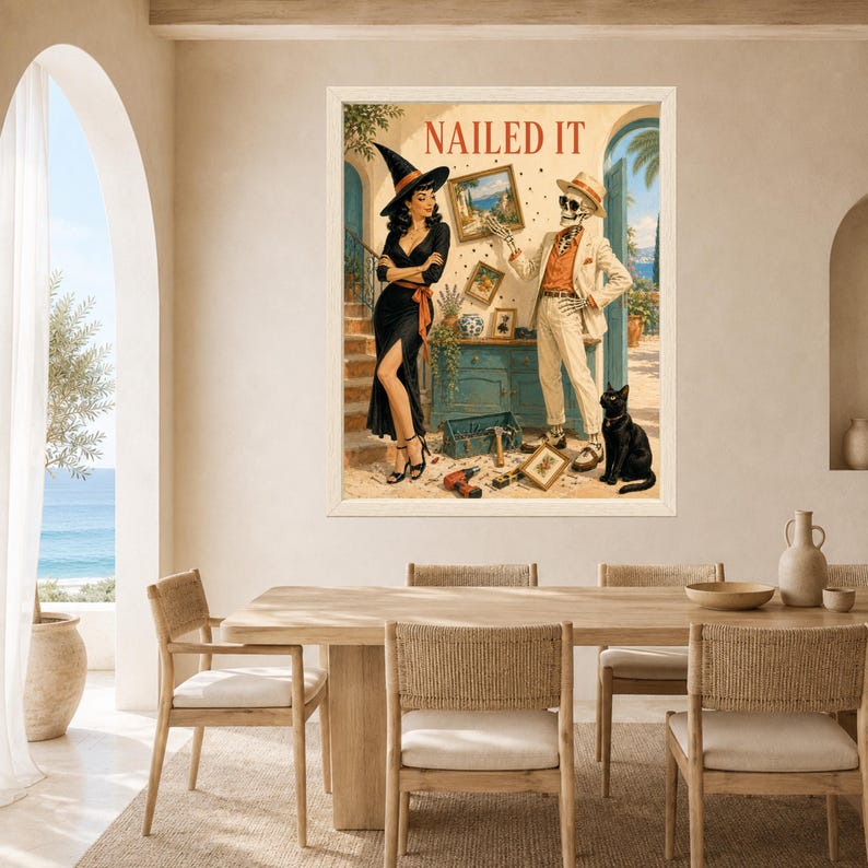 May include: A framed wall art print titled NAILED IT featuring a woman in a black dress and witch hat standing next to a skeleton in a beige suit and hat. A black cat sits nearby, and tools are scattered on the floor in a Mediterranean setting.