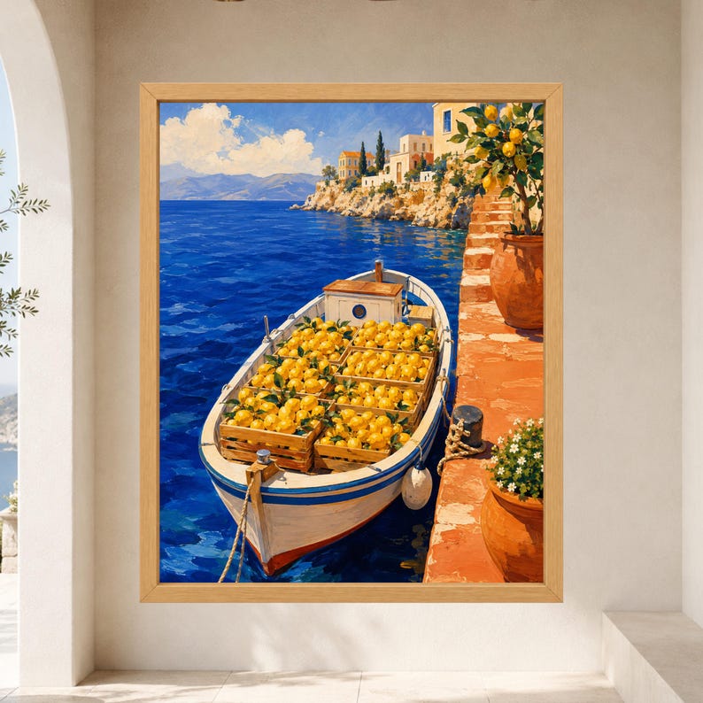 May include: A framed wall art print depicting a white boat filled with wooden crates of bright yellow lemons floating on deep blue water. The scene includes a terracotta-colored stone walkway, potted lemon trees, and coastal buildings.