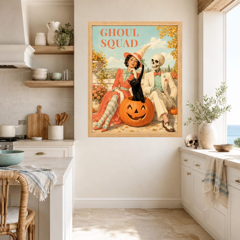 May include: A framed wall art print titled GHOUL SQUAD featuring a vintage-style illustration of a person in a witch hat, a skeleton in a suit, and a black cat sitting inside a carved jack-o'-lantern pumpkin, set against a landscape background.