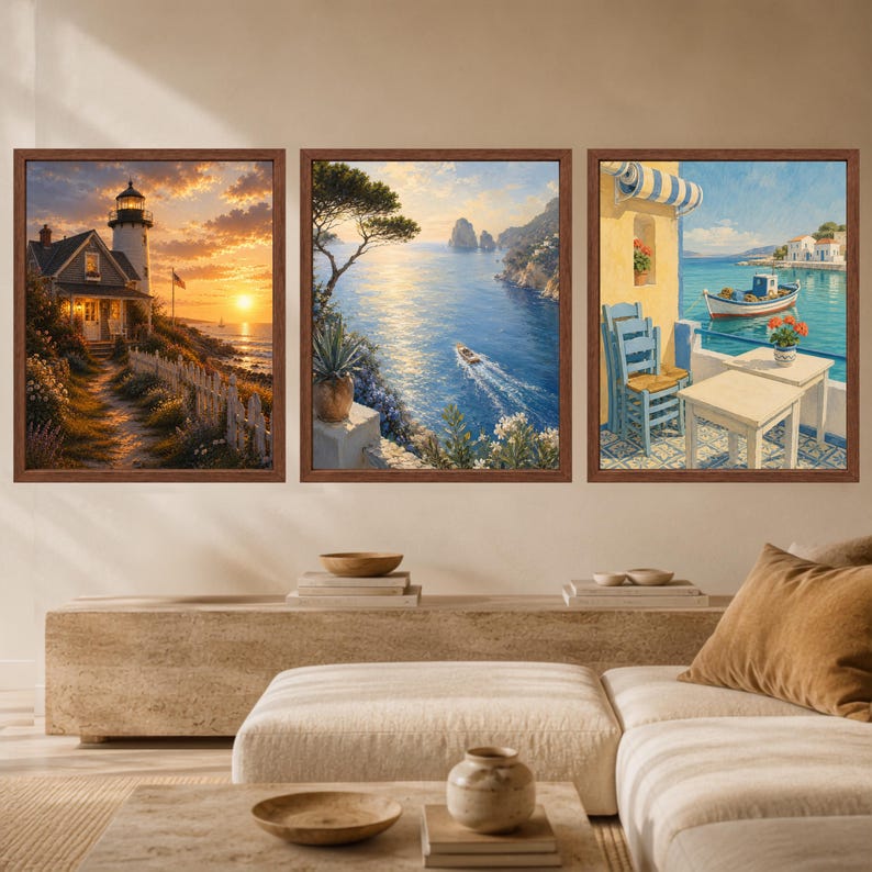 May include: A set of three framed wall art prints featuring coastal scenes. The first shows a lighthouse at sunset, the second a boat on blue water near cliffs, and the third a balcony with a table, chairs, and a boat in the harbor.