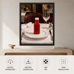 May include: A framed wall art print featuring a red ketchup bottle centered on a white dinner plate. The table setting includes a white napkin, a silver fork, a silver knife, and a clear crystal wine glass, all arranged on a white tablecloth.