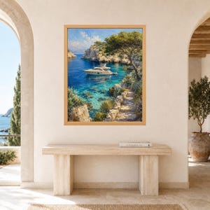 May include: A framed wall art print depicting a white motor yacht anchored in a clear blue Mediterranean cove. The scene features rocky cliffs, lush green trees, and a stone pathway leading toward the water under a bright, partly cloudy sky.