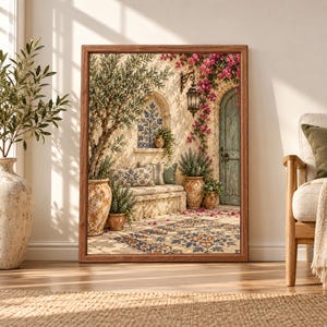 Framed Mediterranean courtyard wall art featuring an olive tree, turquoise rustic door, pink bougainvillea, terracotta pots, blue tile details and warm sunlit stone architecture.