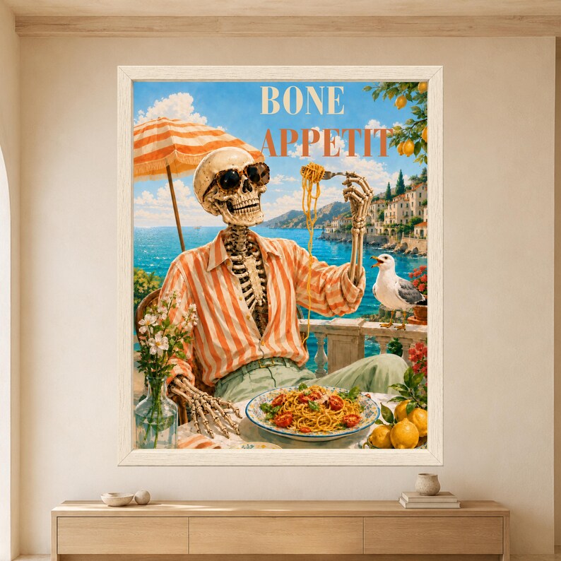 Framed Bone Appetit skeleton wall art featuring a sunglasses-wearing skeleton eating spaghetti on a sunny Mediterranean terrace with lemons, seagull, turquoise sea, sailboats and coastal village.