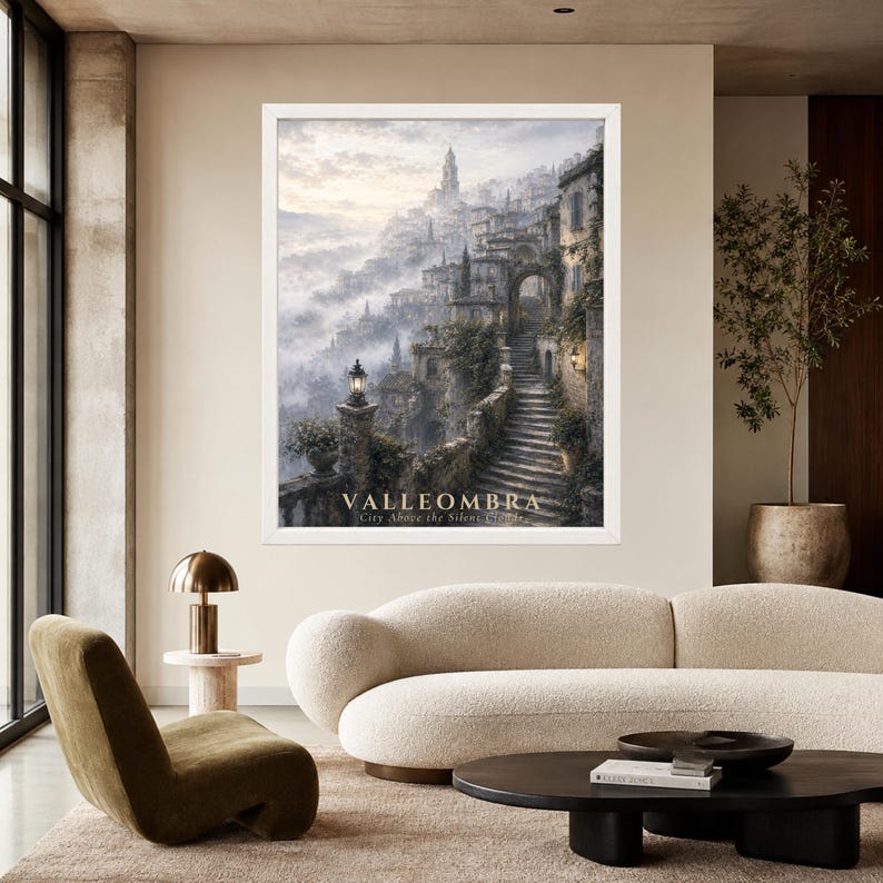 May include: A framed wall art print depicting a misty, hillside village with stone staircases, archways, and lanterns. The text VALLEOMBRA City Above the Silent Clouds is printed at the bottom of the image in a light, serif font.