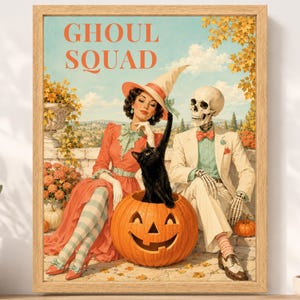 May include: A framed wall art print titled GHOUL SQUAD featuring a person in a witch hat and a skeleton in a suit sitting with a black cat inside a carved pumpkin. The scene includes autumn foliage, a stone wall, and a landscape background.