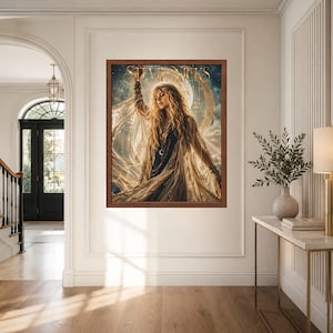 May include: A framed wall art print featuring a portrait of Stevie Nicks with long blonde hair, wearing a dark top and a flowing, sheer, gold-toned shawl. The background displays a large moon and celestial elements with the text Stevie Nicks.