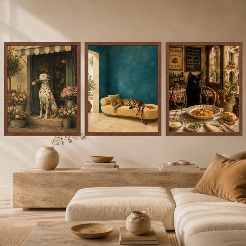 May include: A set of three framed wall art prints. The left print shows a Dalmatian dog with a flower in its mouth. The center print features a leopard resting on a yellow chaise lounge. The right print depicts a black cat at a restaurant table.