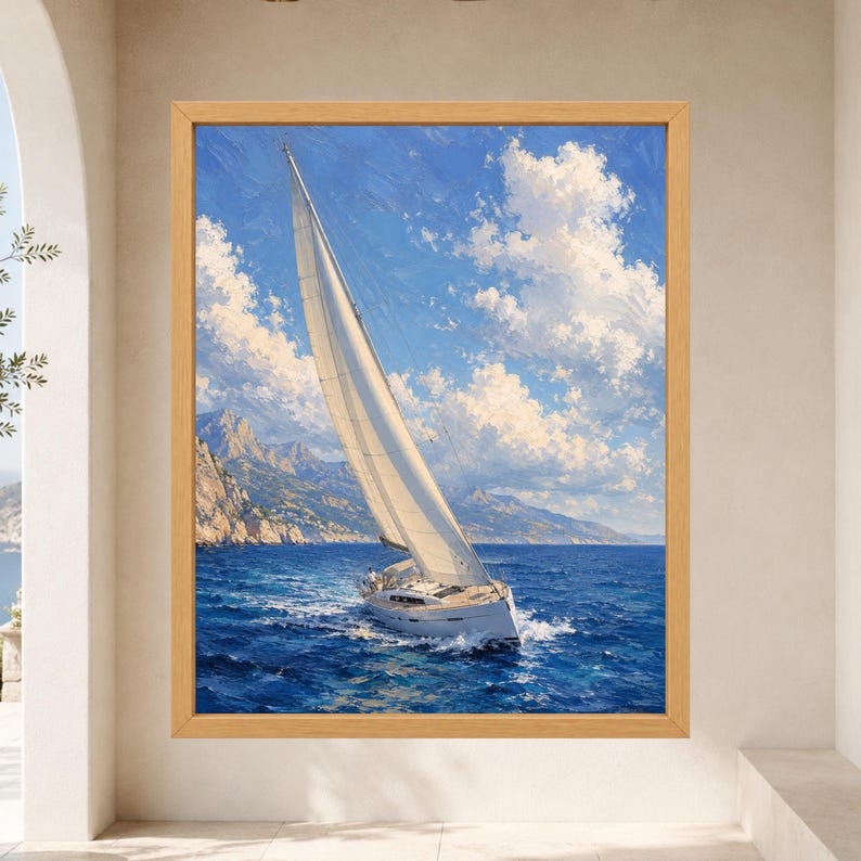 May include: A framed wall art print depicting a white sailboat navigating deep blue ocean waters under a bright sky with fluffy white clouds. The scene includes a distant rocky coastline with mountains, captured in a painterly style with visible brushstrokes.