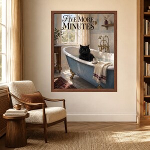 May include: A framed wall art print featuring a black cat sitting in a light blue clawfoot bathtub filled with water. The text "FIVE MORE MINUTES" is printed at the top. A white towel with a red stripe hangs over the edge of the tub.