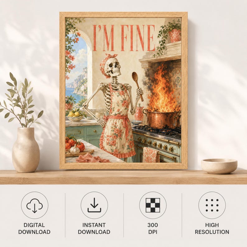 May include: A framed wall art print featuring a skeleton wearing a floral apron and headscarf, standing in a kitchen with a large pot of fire on the stove. The text I'M FINE is printed in red at the top. The scene includes a coastal window view.