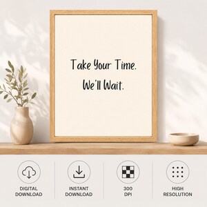 May include: A framed wall art print featuring a light cream background with the black text "Take Your Time. We'll Wait." centered in the frame. The frame is made of light-colored wood. Below the frame are four circular icons for digital download.