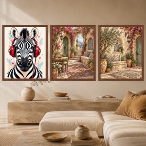 May include: A set of three framed wall art prints. The first print features a black and white zebra wearing bright red headphones. The second and third prints depict a Mediterranean courtyard scene with stone arches, pink flowers, and potted plants.
