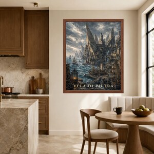 May include: A framed wall art print titled VELA DI PIETRA featuring a detailed illustration of a coastal city with tall stone spires, sailing ships on a turbulent sea, and a glowing lantern in the foreground under a cloudy, dramatic sky.