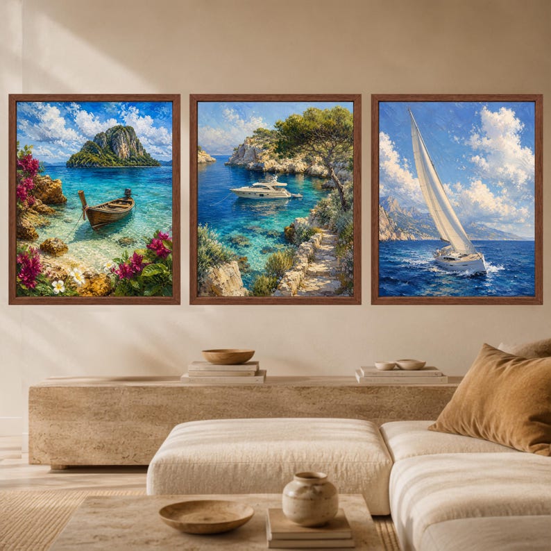 May include: A set of three framed wall art prints featuring coastal scenes. The left print shows a wooden boat in turquoise water with pink flowers. The center print depicts a white yacht near rocky cliffs. The right print shows a sailboat at sea.