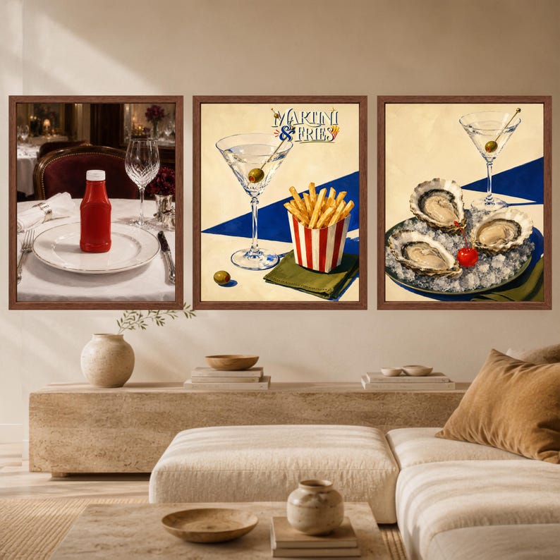 May include: A triptych of framed wall art prints. The left panel shows a red ketchup bottle on a white plate. The center panel features a martini glass, a red and white striped container of french fries, and the text Martini & Fries. The right panel displays three oysters on ice with a martini glass.