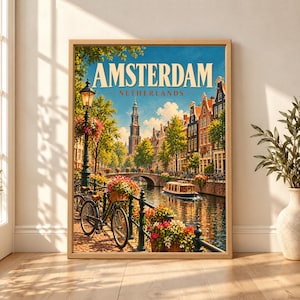 Framed Amsterdam Netherlands travel poster showing a canal with a black bicycle, flower-covered railings, historic Dutch houses, an arched bridge, canal boat and Westerkerk tower under a clear blue sky.
