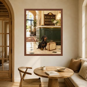 May include: A framed wall art print depicting a black and tan dachshund sitting on a marble floor next to a vintage-style beige suitcase. The scene is set in a hotel lobby with a dark green reception desk, a key rack, and a lamp in the background.