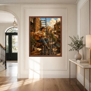 May include: A framed wall art print depicting a person sitting on a metal fire escape, playing an acoustic guitar. The scene shows a city street with brick buildings, laundry hanging on lines, and a bright blue sky with clouds in the background.