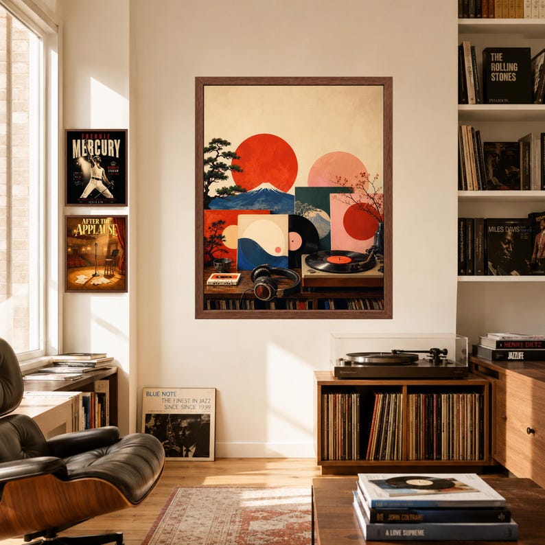 May include: A framed wall art print featuring a stylized landscape with a large red sun, Mount Fuji, a bonsai tree, and a vinyl record player with headphones. The artwork incorporates geometric shapes and warm tones, displayed in a brown wooden frame.