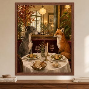May include: A framed wall art print depicting a grey whippet and a red fox sitting opposite each other at a round table in a restaurant. The table is set with two plates of food, wine glasses, candles, and a basket of bread on a white cloth.