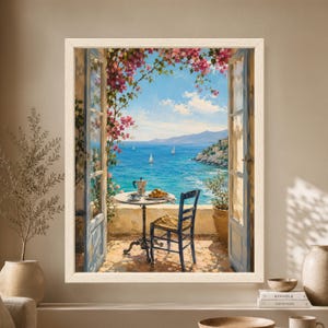 Framed Mediterranean breakfast wall art showing an open blue doorway overlooking turquoise sea and sailboats, with bougainvillea, coffee, a moka pot and croissant on a small café table.
