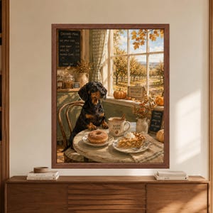 Framed dachshund wall art showing a black and tan dachshund at an autumn orchard cafe table with hot apple cider, a cider donut and apple pie beside a sunny apple orchard.