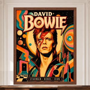 May include: A framed poster featuring a portrait of David Bowie with a red lightning bolt across the face. The text reads DAVID BOWIE at the top and STARMAN REBEL ICON at the bottom. The background includes colorful abstract shapes, planets, and a city skyline.