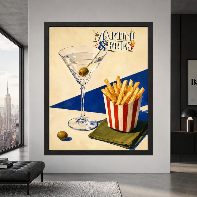 Framed Martini and Fries wall art showing a clear martini glass with green olive beside golden French fries in a red striped carton, with retro lettering and bold blue accents.