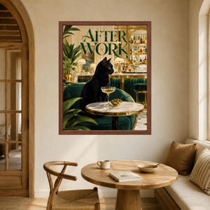 May include: A framed wall art print titled AFTER WORK featuring a black cat sitting on a dark green velvet chair at a small round marble table. On the table sits a stemmed cocktail glass and a small bowl of green olives in a bar setting.