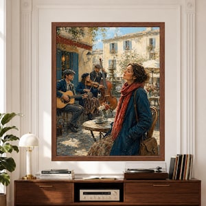 Framed French cafe jazz wall art featuring an acoustic trio playing guitar, violin and upright bass in a sunlit European courtyard while a woman listens from a cafe table surrounded by pale buildings, blue shutters and flowers above a record player console.