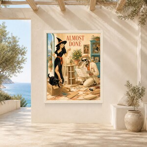 May include: A framed wall art print titled ALMOST DONE featuring a woman in a black witch hat and dress standing next to a skeleton wearing a hat and sunglasses who is reading instructions while assembling furniture with a black cat in a box.