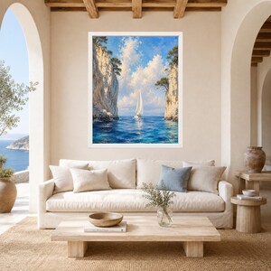 May include: A framed landscape painting featuring a white sailboat navigating through a narrow passage between two tall, light-colored rocky cliffs. The scene includes deep blue water, a bright blue sky with white clouds, and green trees atop the cliffs.