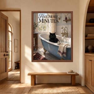 May include: A framed wall art print featuring a black cat sitting in a blue clawfoot bathtub filled with water. The text FIVE MORE MINUTES is printed at the top. A white towel with red stripes hangs over the edge of the tub next to a small cup.